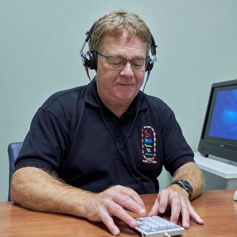 A male participant completes a hearing test at a CLSA Data Collection Site.